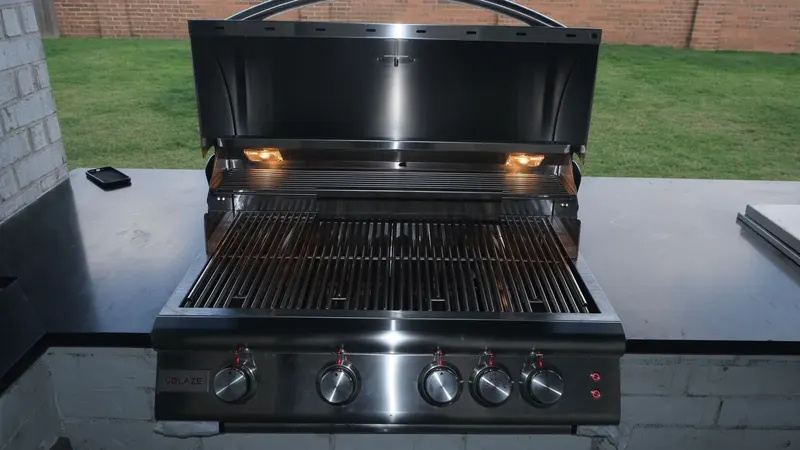 Stainless built-in gas grill with the lid open