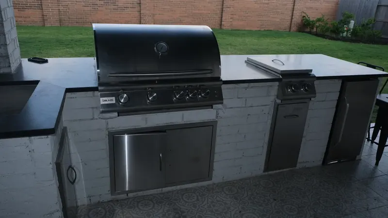 L-shaped outdoor kitchen with white brick base and black granite counters, Aristad Ln, Cypress TX