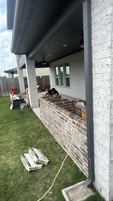 Laying the block and brick base for the outdoor kitchen
