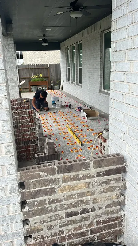 Patterned porcelain tile going down on the patio floor