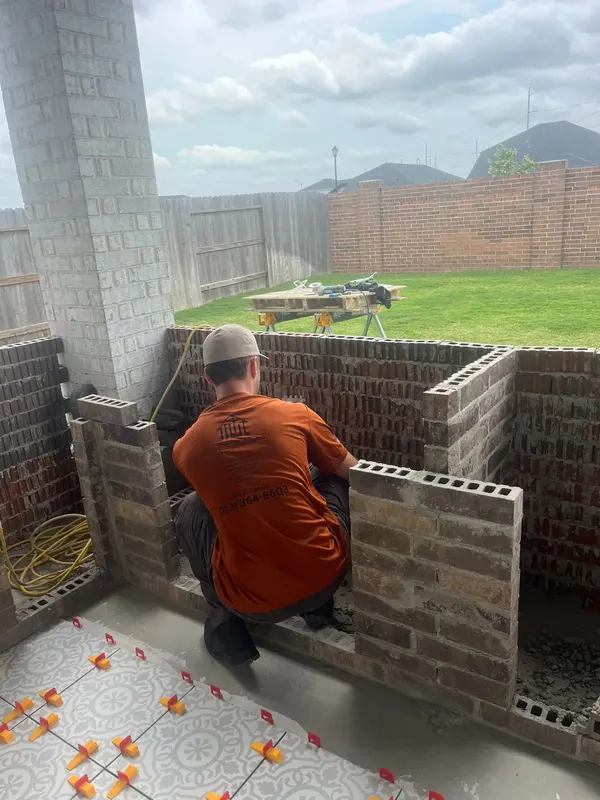 Brick walls of the outdoor kitchen base with openings for the appliances