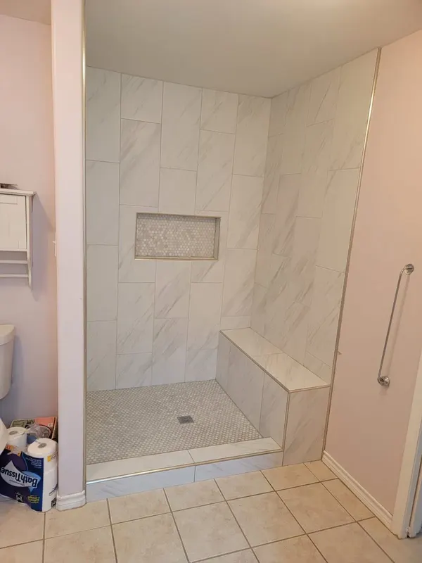 Walk-in shower with marble-look porcelain tile, bench and hex mosaic floor, Regal Hill Ct, Montgomery TX