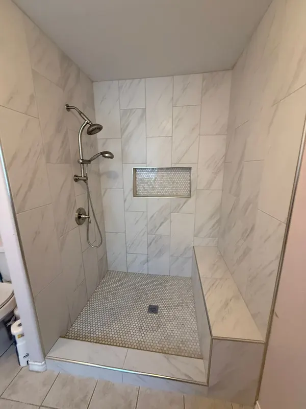 Tiled bench and recessed niche in the new walk-in shower
