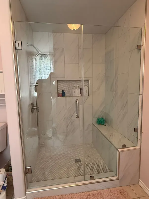Frameless glass shower door on the finished walk-in shower