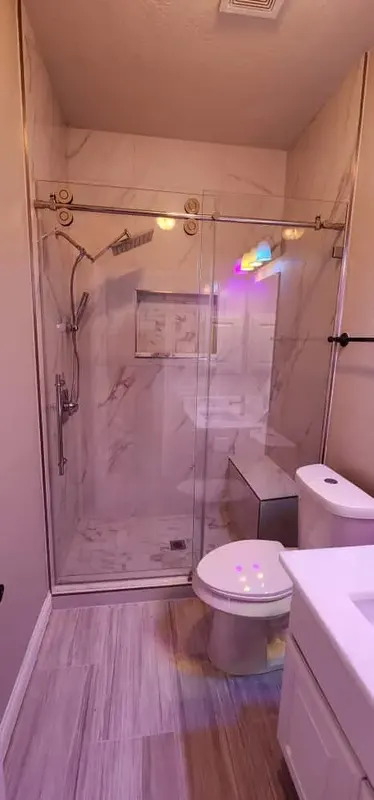 Shower bench, niche and handheld fixture in the finished Pearland shower