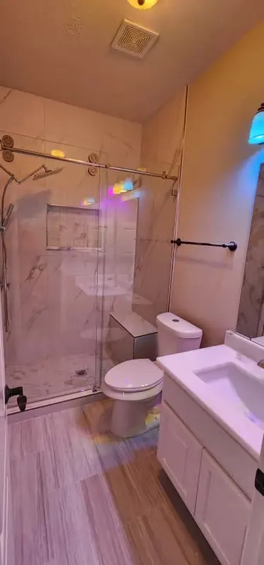 Finished shower next to the new toilet and vanity