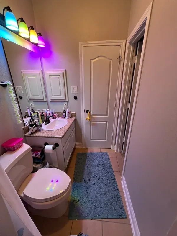 Before: the original bathroom with vanity and tub area