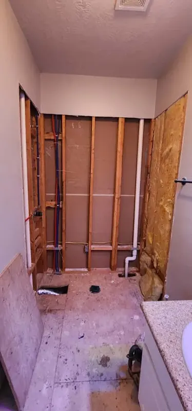 Shower opened to the studs with new plumbing