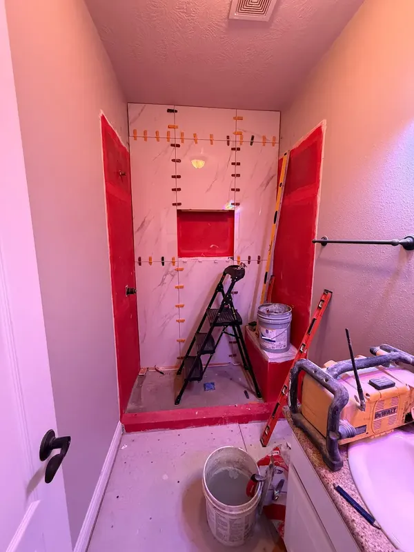 Tile going up over the waterproofed shower walls