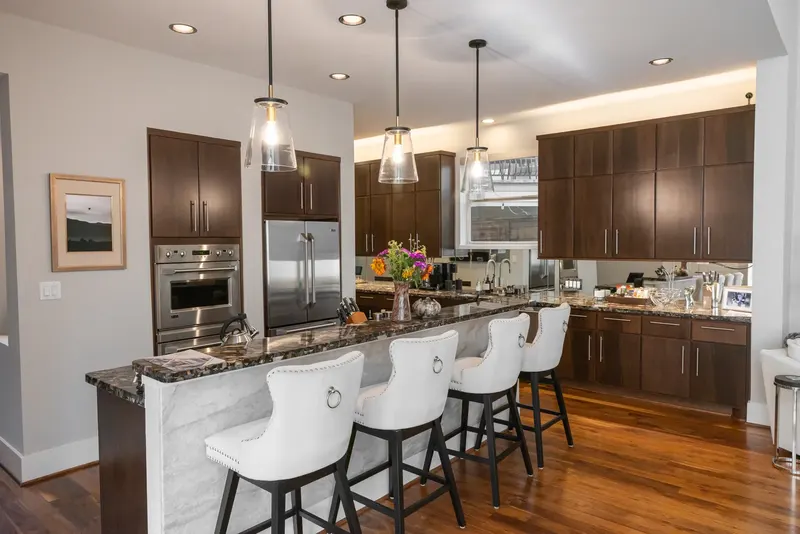 Townhome kitchen with flat-panel cabinets and a quartzite island on Feagan St (Feagan St, Rice Military)