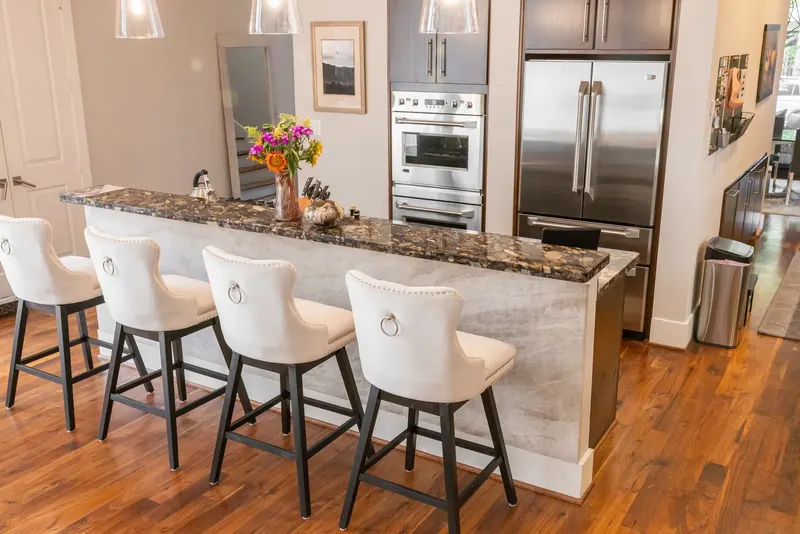 Townhome kitchen with flat-panel cabinets and a quartzite island on Feagan St (Feagan St, Rice Military)