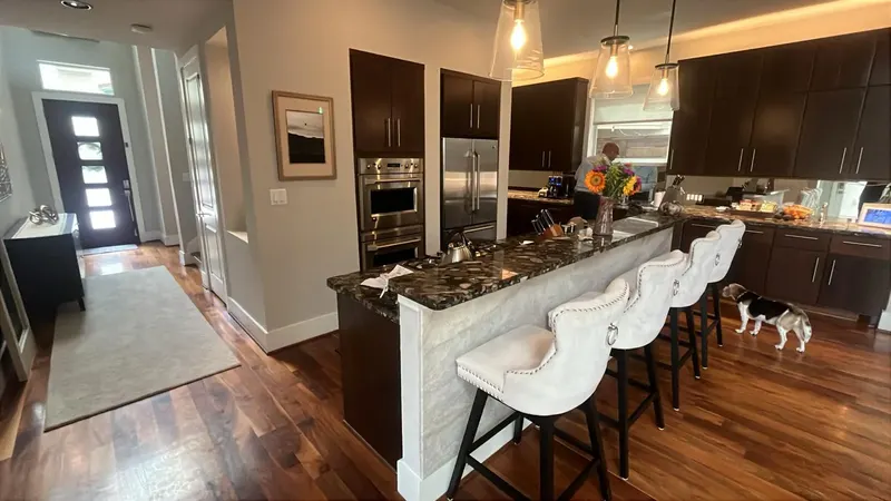 Townhome kitchen with flat-panel cabinets and a quartzite island on Feagan St (Feagan St, Rice Military)
